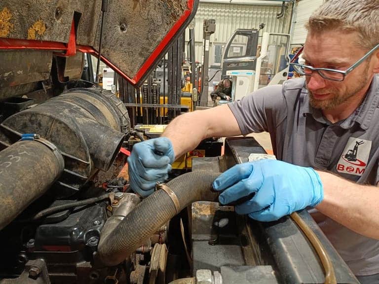 Image d'un technicien durant la maintenance d'un chariot élévateur