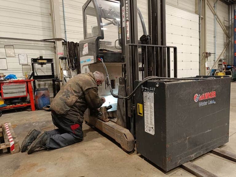 Image d'un technicien de maintenance durant l'entretien d'un gerbeur